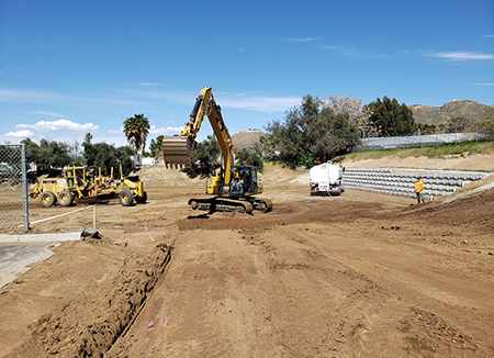 Photo Of An Edmondson Construction CAT Excavator, Scraper And Water Truck At The Jobsite